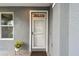 Welcoming front entrance featuring a stylish door, a small window and neutral tones at 2667 Aspen Ct, Palm Harbor, FL 34684