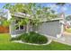 Charming single-story home with a well-manicured front yard and lush landscaping at 2667 Aspen Ct, Palm Harbor, FL 34684