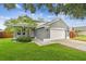 Charming single-Gathering home featuring a two-car garage, well-manicured lawn, and beautiful landscaping at 2667 Aspen Ct, Palm Harbor, FL 34684