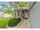 Inviting home entrance with vibrant greenery, stone accents, and a clean, well-maintained walkway at 2667 Aspen Ct, Palm Harbor, FL 34684