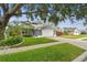 Well-maintained single-Gathering home with a manicured lawn, two-car garage, and a welcoming curb appeal at 2667 Aspen Ct, Palm Harbor, FL 34684