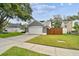 Lovely single-Gathering home with a two-car garage, green lawn, and a charming fenced yard at 2667 Aspen Ct, Palm Harbor, FL 34684