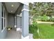 Charming porch showcasing architectural details, neutral colors, and manicured landscaping at 2667 Aspen Ct, Palm Harbor, FL 34684