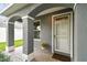Inviting front porch featuring decorative columns and neutral tones with a lovely front door at 2667 Aspen Ct, Palm Harbor, FL 34684