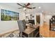 Comfortable home office with wood desk, ceiling fan, and colorful art at 2667 Aspen Ct, Palm Harbor, FL 34684