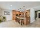 Kitchen with a breakfast bar, stainless steel appliances, and adjacent dining area at 2667 Aspen Ct, Palm Harbor, FL 34684