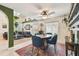 Bright living and dining area with blue chairs, ceiling fan, and comfortable seating at 2667 Aspen Ct, Palm Harbor, FL 34684
