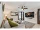 Comfortable living room showcasing a gray sofa, large screen TV, and natural lighting at 2667 Aspen Ct, Palm Harbor, FL 34684