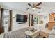 Spacious living area with a large TV, sliding glass doors, and view of the backyard at 2667 Aspen Ct, Palm Harbor, FL 34684