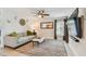 Comfortable living room showcasing a gray sofa, large screen TV, and natural lighting at 2667 Aspen Ct, Palm Harbor, FL 34684