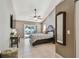 Bedroom featuring a ceiling fan, sliding glass doors, and warm neutral paint at 2667 Aspen Ct, Palm Harbor, FL 34684