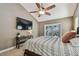 Bedroom featuring a ceiling fan, sliding glass doors, and warm neutral paint at 2667 Aspen Ct, Palm Harbor, FL 34684