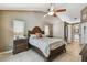 Bedroom featuring neutral colors, ceiling fan, and a view to the en suite bathroom at 2667 Aspen Ct, Palm Harbor, FL 34684
