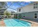 Well-maintained home with a pristine screened-in pool and seating at 2667 Aspen Ct, Palm Harbor, FL 34684