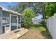 View of screened-in pool and patio from the backyard at 2667 Aspen Ct, Palm Harbor, FL 34684