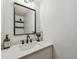 Beautiful powder room features a modern vanity, large mirror, stylish light fixture, and designer finishes at 2667 Aspen Ct, Palm Harbor, FL 34684