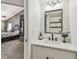 Half bathroom features a modern vanity, stylish lighting, and designer mirror, conveniently located near the bedroom at 2667 Aspen Ct, Palm Harbor, FL 34684
