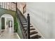 Elegant staircase featuring dark wood railings and posts, leads to the upper level of this beautiful home at 2667 Aspen Ct, Palm Harbor, FL 34684