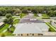 This aerial view shows the house, with its neat yard, nearby trees, and the layout of the community at 2973 Breezy Meadows, Clearwater, FL 33760