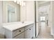 Bathroom featuring gray vanity with quartz countertop and views to additional rooms at 2973 Breezy Meadows, Clearwater, FL 33760