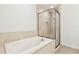 Bright bathroom featuring soaking tub, glass shower, and tiled walls at 2973 Breezy Meadows, Clearwater, FL 33760