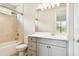 Bright bathroom featuring a shower-over-tub and modern gray vanity with white countertop at 2973 Breezy Meadows, Clearwater, FL 33760