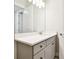 Bathroom with a white countertop, gray vanity, and a large mirror with modern lighting at 2973 Breezy Meadows, Clearwater, FL 33760