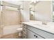 Bathroom showcasing tub and shower combo, gray vanity cabinet, and neutral tile flooring at 2973 Breezy Meadows, Clearwater, FL 33760
