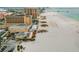 Expansive beach view showcasing beachfront condos, volleyball courts, and pristine sandy shores at 2973 Breezy Meadows, Clearwater, FL 33760