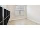Bright bedroom featuring wood-look tile floors and natural light from a large window at 2973 Breezy Meadows, Clearwater, FL 33760