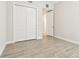 Empty bedroom with closet and wood-look tile floors at 2973 Breezy Meadows, Clearwater, FL 33760