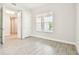 This bedroom features an adjacent doorway and a bright window at 2973 Breezy Meadows, Clearwater, FL 33760