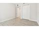 Bedroom with white closet doors and wood-style flooring and a hallway view at 2973 Breezy Meadows, Clearwater, FL 33760