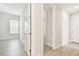 Bedroom with wood tile flooring, a window with blinds, and a door leading to the hallway at 2973 Breezy Meadows, Clearwater, FL 33760
