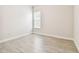 Neutral bedroom featuring wood-look tile floors and a bright window at 2973 Breezy Meadows, Clearwater, FL 33760