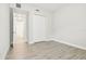 Empty bedroom with a double door closet and wood tile flooring at 2973 Breezy Meadows, Clearwater, FL 33760
