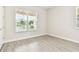 Bright bedroom with wood-look tile and a large window at 2973 Breezy Meadows, Clearwater, FL 33760