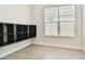 Bright bedroom with a modern shelving unit, featuring a window and wood-look flooring at 2973 Breezy Meadows, Clearwater, FL 33760