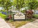 Palm Crest Place neighborhood sign, surrounded by plants, and greenery, creates a warm inviting entrance at 2973 Breezy Meadows, Clearwater, FL 33760