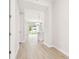 Bright entryway featuring wood-look tile flooring and an open floor plan at 2973 Breezy Meadows, Clearwater, FL 33760
