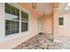 Covered front porch with brick pavers and view of a window at 2973 Breezy Meadows, Clearwater, FL 33760