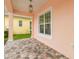 Covered front porch featuring stone pavers, hanging lights, and white pillars at 2973 Breezy Meadows, Clearwater, FL 33760