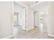 Bright hallway with wood-look tile floors, leading to bedrooms and living areas at 2973 Breezy Meadows, Clearwater, FL 33760