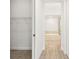 Hallway featuring wood-look tile floors, a closet, and access to the bathroom at 2973 Breezy Meadows, Clearwater, FL 33760
