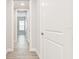 Hallway with tile floors and white doors leading to different rooms in the home at 2973 Breezy Meadows, Clearwater, FL 33760