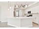 Bright kitchen boasts white cabinets, stainless appliances, and an expansive center island at 2973 Breezy Meadows, Clearwater, FL 33760