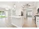 Open-concept kitchen with large island, stainless appliances, and seamless flow to other rooms at 2973 Breezy Meadows, Clearwater, FL 33760