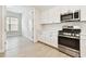 Modern kitchen with stainless steel appliances and a view to a bright bedroom at 2973 Breezy Meadows, Clearwater, FL 33760