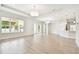 Bright open living room features wood-look tile flooring, backyard views and recessed lighting at 2973 Breezy Meadows, Clearwater, FL 33760