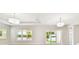 Open living room with natural light, sliding glass door, and view of landscaped backyard at 2973 Breezy Meadows, Clearwater, FL 33760